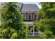 Brick home featuring three second story windows and a covered front porch framed by mature trees at 623 Brennan Dr, Decatur, GA 30033
