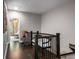 Upstairs hallway with wood floors and a stylish decorative bench at 623 Brennan Dr, Decatur, GA 30033