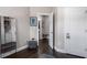 Hallway view with a doorway, mirror, coat rack, and dark hardwood floors at 623 Brennan Dr, Decatur, GA 30033