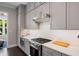 Well-appointed kitchen features gray cabinets, stainless steel appliances, and subway tile backsplash at 623 Brennan Dr, Decatur, GA 30033
