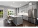 Modern kitchen with gray cabinets, a center island with seating, stainless steel appliances, and hardwood floors at 623 Brennan Dr, Decatur, GA 30033