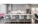 Gourmet kitchen has a large island with seating, gray cabinets, and stainless steel appliances at 623 Brennan Dr, Decatur, GA 30033