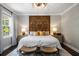 Main bedroom featuring a decorative wood headboard and stylish decor at 623 Brennan Dr, Decatur, GA 30033