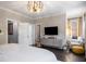 Bright bedroom featuring a large TV, windows and a comfortable seating area at 623 Brennan Dr, Decatur, GA 30033