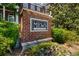 Brick sign that reads: The Mews - North Decatur with landscaping at 623 Brennan Dr, Decatur, GA 30033