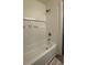 Bright bathroom with a white tub and shower with tile surround and recessed niche at 5674 Kingsport Dr # 4, Atlanta, GA 30342