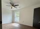 Bedroom features a ceiling fan, wood-look floors, and a window offering natural light at 5674 Kingsport Dr # 4, Atlanta, GA 30342