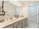 Double vanity bathroom with white cabinets, a large mirror, and a shower/tub combo at 5767 Wembley Dr, Douglasville, GA 30135