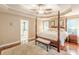 Spacious bedroom with a four-poster bed, tray ceiling, and hardwood floors at 5767 Wembley Dr, Douglasville, GA 30135