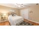 Bedroom with a bed, white bedding, wood floors and double door closets at 5767 Wembley Dr, Douglasville, GA 30135