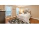 Cozy bedroom with wood floors, neutral walls, and a bed with white bedding at 5767 Wembley Dr, Douglasville, GA 30135