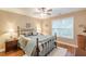 Inviting bedroom featuring natural light, hardwood floors, and cozy bedding at 5767 Wembley Dr, Douglasville, GA 30135