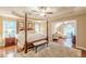 Bedroom featuring a four-poster bed, sitting area, and ample natural light at 5767 Wembley Dr, Douglasville, GA 30135