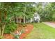 View of charming home with lush lawn and landscaping, mature trees offering shade and curb appeal at 5767 Wembley Dr, Douglasville, GA 30135