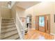 Inviting foyer with hardwood floors, staircase, and natural light streaming through the front door at 5767 Wembley Dr, Douglasville, GA 30135