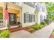 Inviting entrance with the front door framed by brick steps, lush plants, and an American flag at 5767 Wembley Dr, Douglasville, GA 30135