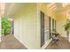 Inviting porch with a small table and chair set, enhanced by the natural beauty of the surrounding greenery at 5767 Wembley Dr, Douglasville, GA 30135