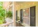 Charming front porch with an inviting seating area, complete with an ornate fern hanging from the ceiling at 5767 Wembley Dr, Douglasville, GA 30135