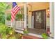 Cozy front porch with an American flag, 'WELCOME' decor, and a charming seating area at 5767 Wembley Dr, Douglasville, GA 30135