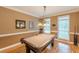 Well-lit game room with a classic billiard table and elegant chandelier, perfect for entertaining at 5767 Wembley Dr, Douglasville, GA 30135