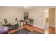 A game room with wood floors featuring workout equipment and a Monopoly pinball machine at 5767 Wembley Dr, Douglasville, GA 30135