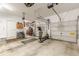 Spacious garage with exercise equipment, storage, and bright lighting showing the depth and functionality of the space at 5767 Wembley Dr, Douglasville, GA 30135