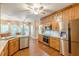 Open kitchen with stainless steel appliances, custom wood cabinets, and granite countertops at 5767 Wembley Dr, Douglasville, GA 30135