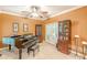 Bright living room featuring a piano, display cabinets, and French doors leading outside at 5767 Wembley Dr, Douglasville, GA 30135