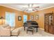 Cozy living room featuring a grand piano, comfortable seating, and ample natural light at 5767 Wembley Dr, Douglasville, GA 30135