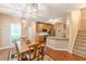 Open living area with wood floors, a dining table and a view into the kitchen at 5767 Wembley Dr, Douglasville, GA 30135
