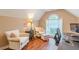 Well-lit office area with comfortable seating, arched window, and desk at 5767 Wembley Dr, Douglasville, GA 30135