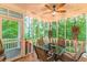 Well-lit screened porch with a ceiling fan, ideal for outdoor dining and gatherings at 5767 Wembley Dr, Douglasville, GA 30135