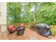 Spacious wooden deck with outdoor seating and a grill, perfect for summer barbecues at 5767 Wembley Dr, Douglasville, GA 30135