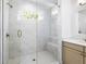 Elegant bathroom with a glass shower and neutral-toned vanity at 205 Mayfair Ct, Alpharetta, GA 30009