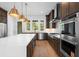 Modern kitchen with stainless steel appliances, tile backsplash, and a large center island at 205 Mayfair Ct, Alpharetta, GA 30009