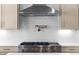 Close-up of kitchen featuring stainless steel range, white subway tile backsplash, and pot filler faucet at 205 Mayfair Ct, Alpharetta, GA 30009