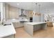 Open concept kitchen with large island, stainless steel appliances, stone countertops, and pendant lighting at 205 Mayfair Ct, Alpharetta, GA 30009