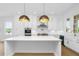 Spacious kitchen with stainless steel appliances, white cabinets, a large island, and hardwood floors at 205 Mayfair Ct, Alpharetta, GA 30009