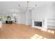 Open concept living space with hardwood floors, fireplace, and kitchen view at 205 Mayfair Ct, Alpharetta, GA 30009