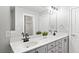 A bathroom featuring a double vanity with quartz countertops, framed mirrors, and modern fixtures at 2766 Wander Ln, Alpharetta, GA 30022