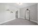 Charming bedroom with stylish wallpaper, mirror, and a doorway to a bathroom at 2766 Wander Ln, Alpharetta, GA 30022