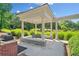 An outdoor gazebo features benches, a grill, and views of the green community lawn at 2766 Wander Ln, Alpharetta, GA 30022