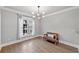 Elegant dining room featuring hardwood floors, modern light fixture, and a large window at 2766 Wander Ln, Alpharetta, GA 30022
