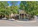 Elegant building exterior with arched windows, shaded outdoor seating, and tree-lined street at 2766 Wander Ln, Alpharetta, GA 30022