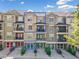 Townhome exterior showcasing multiple balconies, garage doors, and colorful front doors at 2766 Wander Ln, Alpharetta, GA 30022