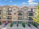 Townhome exterior showcasing multiple balconies, garage doors, and colorful front doors at 2766 Wander Ln, Alpharetta, GA 30022