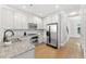 Modern kitchen featuring granite countertops, stainless steel appliances, and pristine white cabinetry at 2766 Wander Ln, Alpharetta, GA 30022