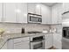 Sleek kitchen showcasing granite countertops, stainless steel appliances, and white cabinets that blend style and function at 2766 Wander Ln, Alpharetta, GA 30022