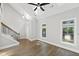 Hardwood flooring, staircase, skylights, and windows fill this living room with elegance and natural light at 2766 Wander Ln, Alpharetta, GA 30022