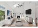 Bright living room with vaulted ceilings, fireplace, built-in shelving, and hardwood floors for elegant appeal at 2766 Wander Ln, Alpharetta, GA 30022